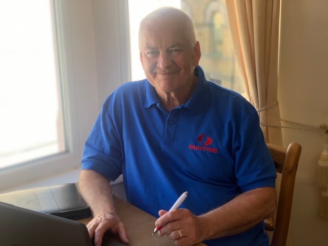 Denis Elkins in his office at home