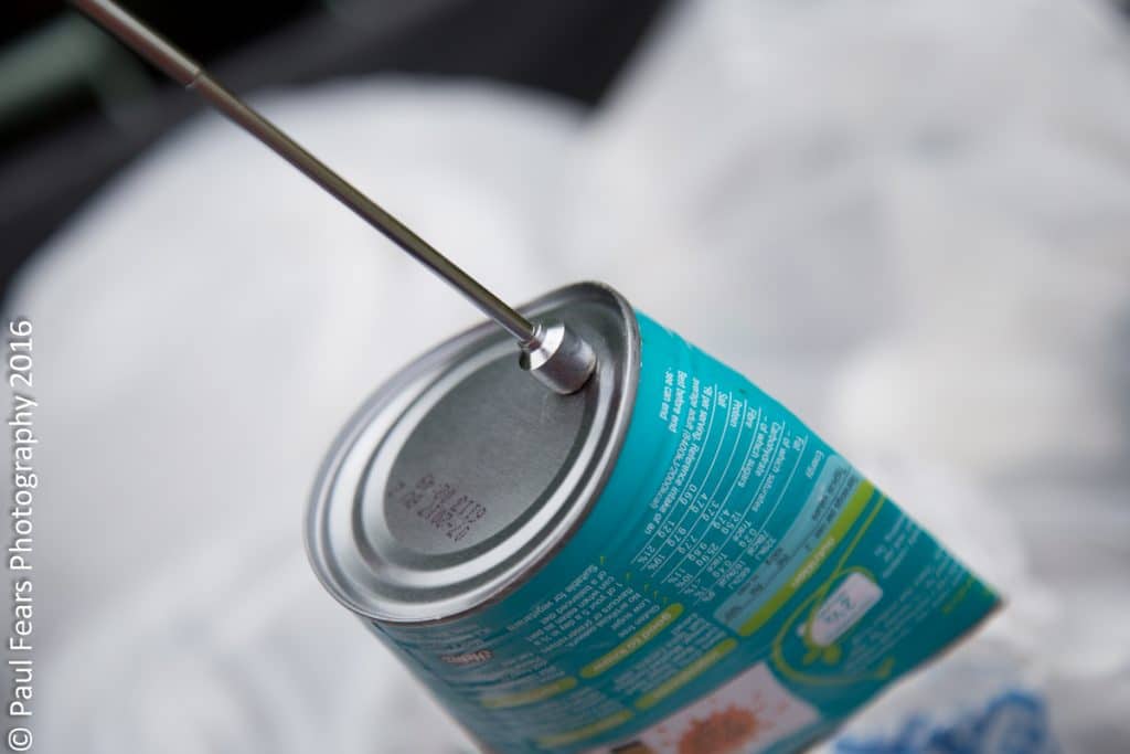 Magnet holding up a steel can 